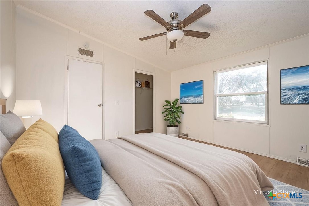105 Grace Road Belton, TX 76513 - Photo 4 of 25 a spacious bedroom with a large bed and a chandelier