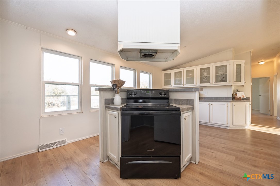 105 Grace Road Belton, TX 76513 - Photo 7 of 25 a kitchen with stainless steel appliances granite countertop a stove and a sink