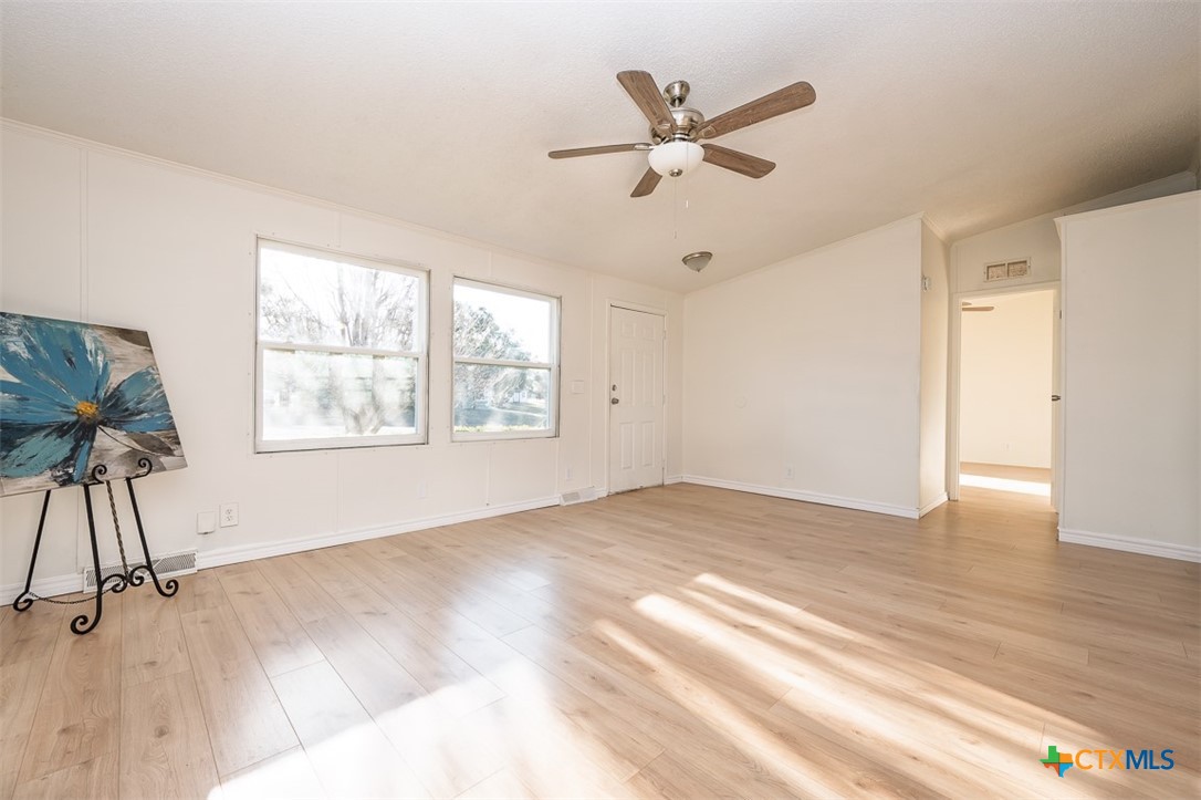 105 Grace Road Belton, TX 76513 - Photo 10 of 25 wooden floor in an empty room with a window