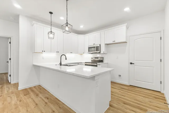 a kitchen with a sink stove and cabinets