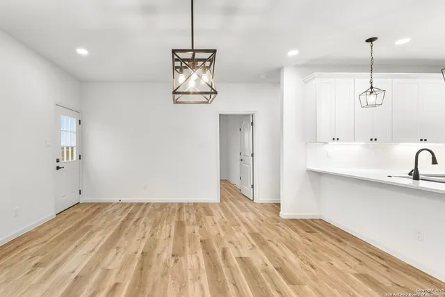 a view of a kitchen with a sink and wooden floor