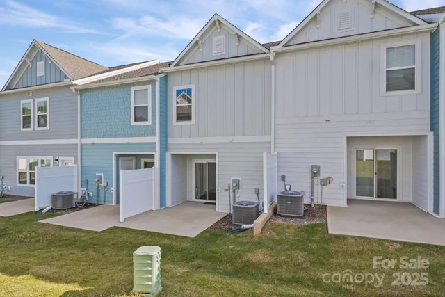 a view of a house with a yard patio and fire pit