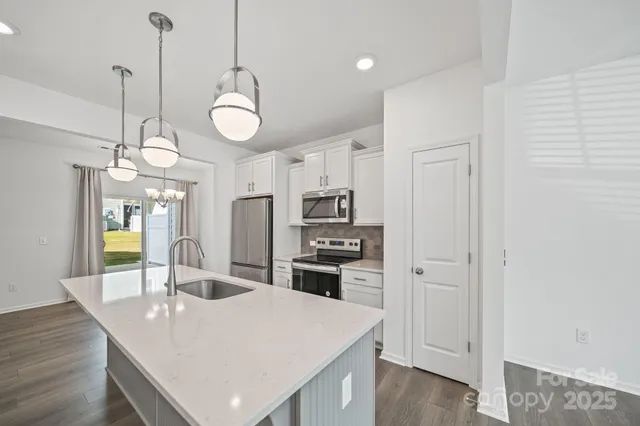 a kitchen with a table and chairs in it