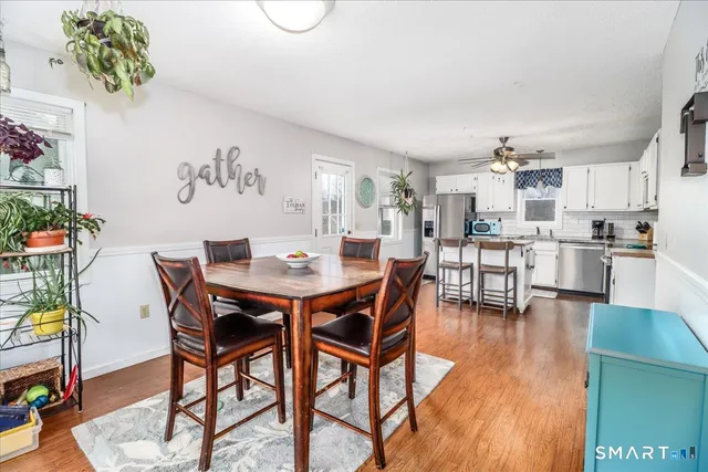 a view of a dining room with furniture and wooden floor