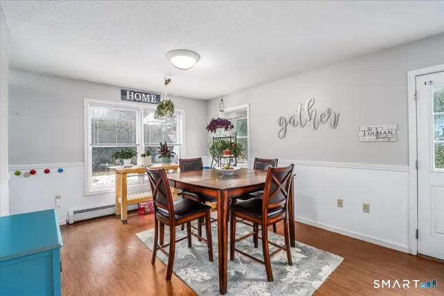 a view of a dining room with furniture window and wooden floor