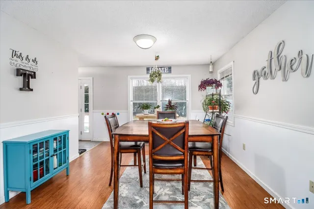 a view of a dining room with furniture and wooden floor