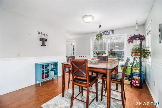 a view of a dining room with furniture and wooden floor