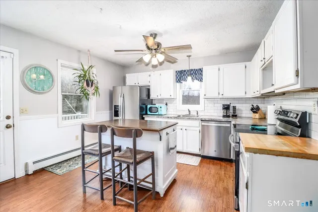 a kitchen with a table chairs stove and cabinets