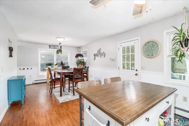 a living room with dining table and a wooden floor