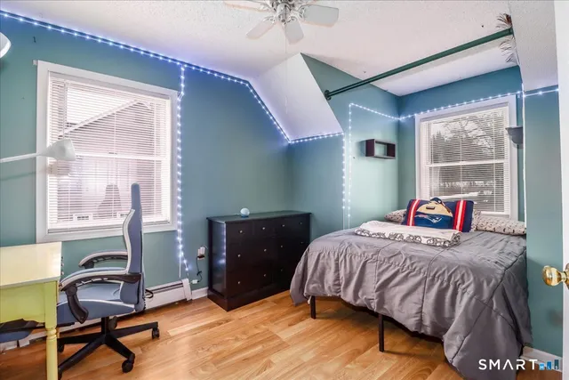 a bedroom with a bed and a window