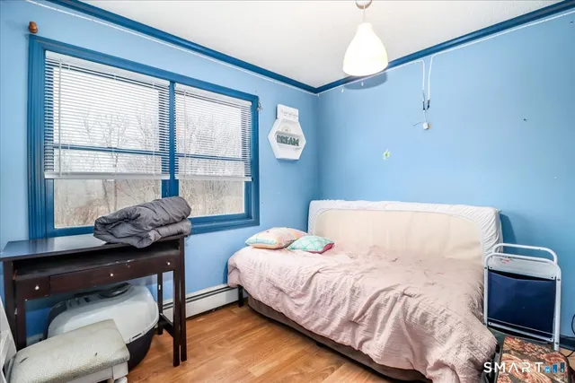 a bedroom with a bed and a window