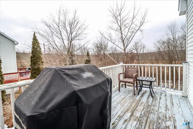 a view of balcony with wooden floor and outdoor seating