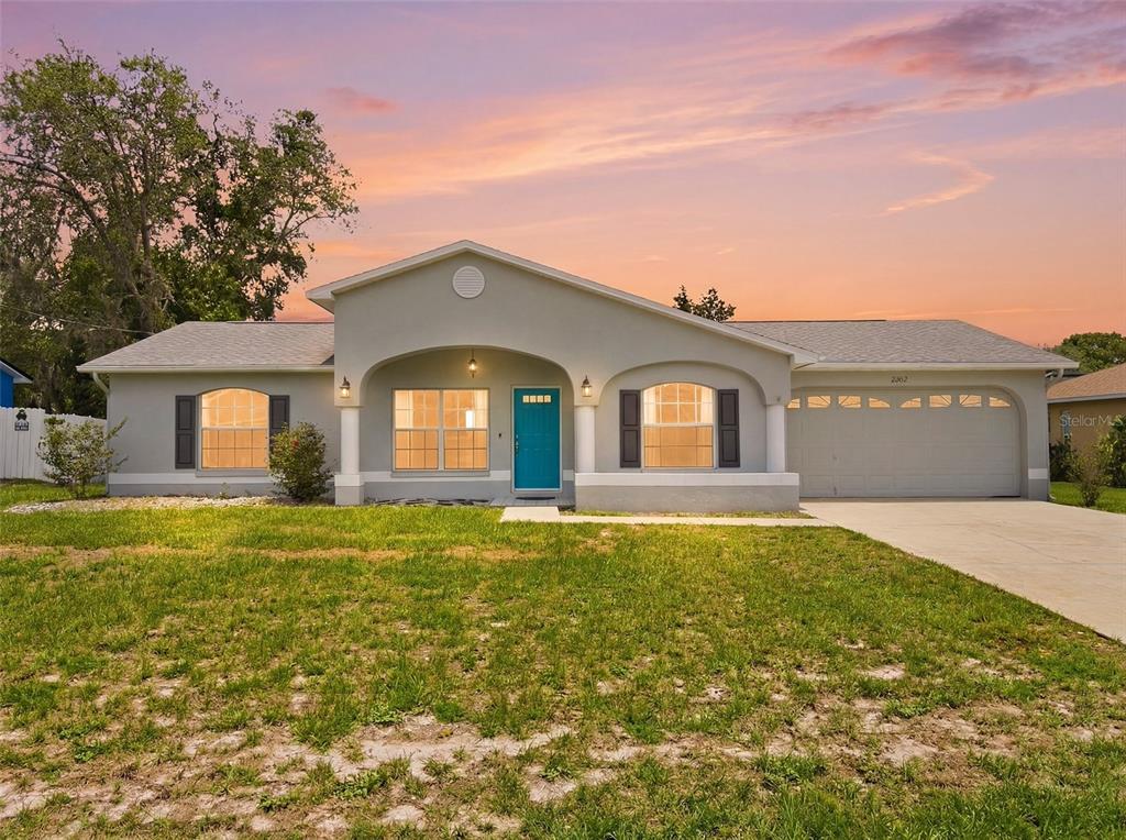 2202 Godfrey Avenue Spring Hill, FL 34609 - Photo 1 of 36 a front view of a house with a yard