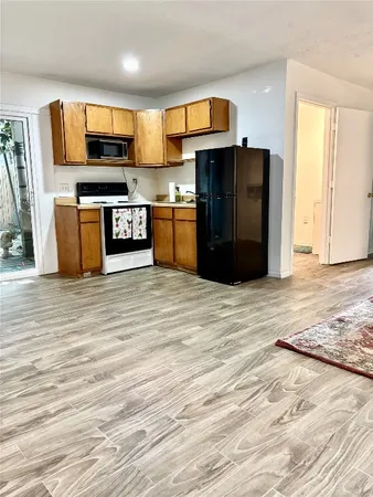 a kitchen with stainless steel appliances kitchen island granite countertop a refrigerator and a stove top oven