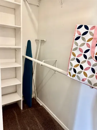 a view of walk in closet with empty racks
