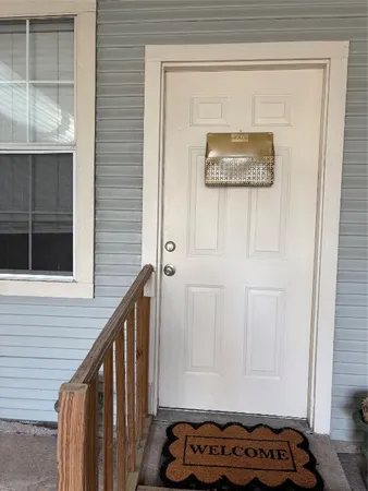 a view of a hallway with a door and a window