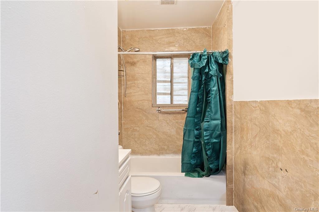 1653 Garfield Street Bronx, NY 10460 - Photo 12 of 21 a bathroom with a toilet and a shower