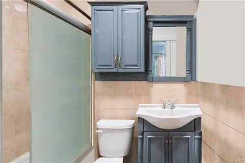 a bathroom with a sink a toilet and mirror