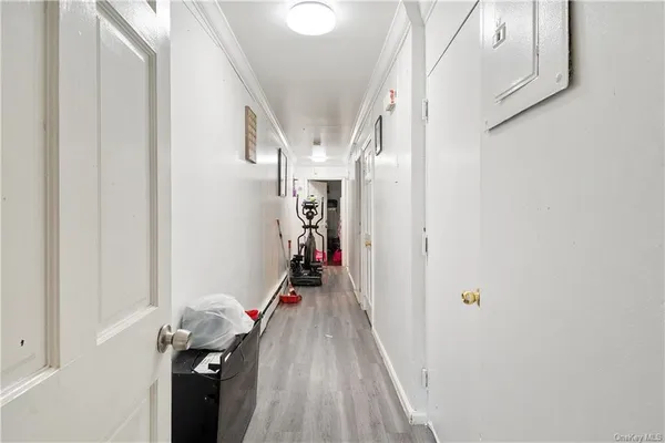 a view of hallway with wooden floor