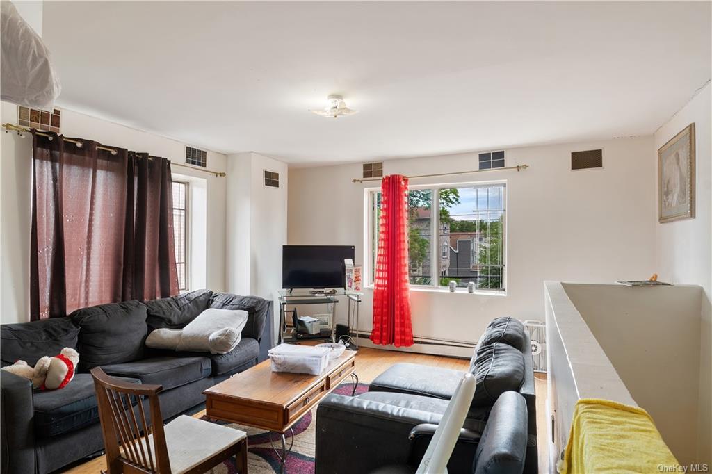 1653 Garfield Street Bronx, NY 10460 - Photo 18 of 21 a living room with furniture a flat screen tv and a window