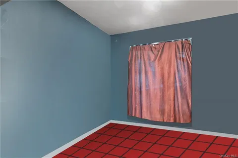 a view of a room with wooden floor and a window