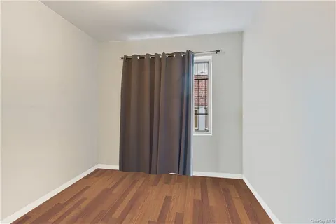a view of a small space with wooden floor and closet