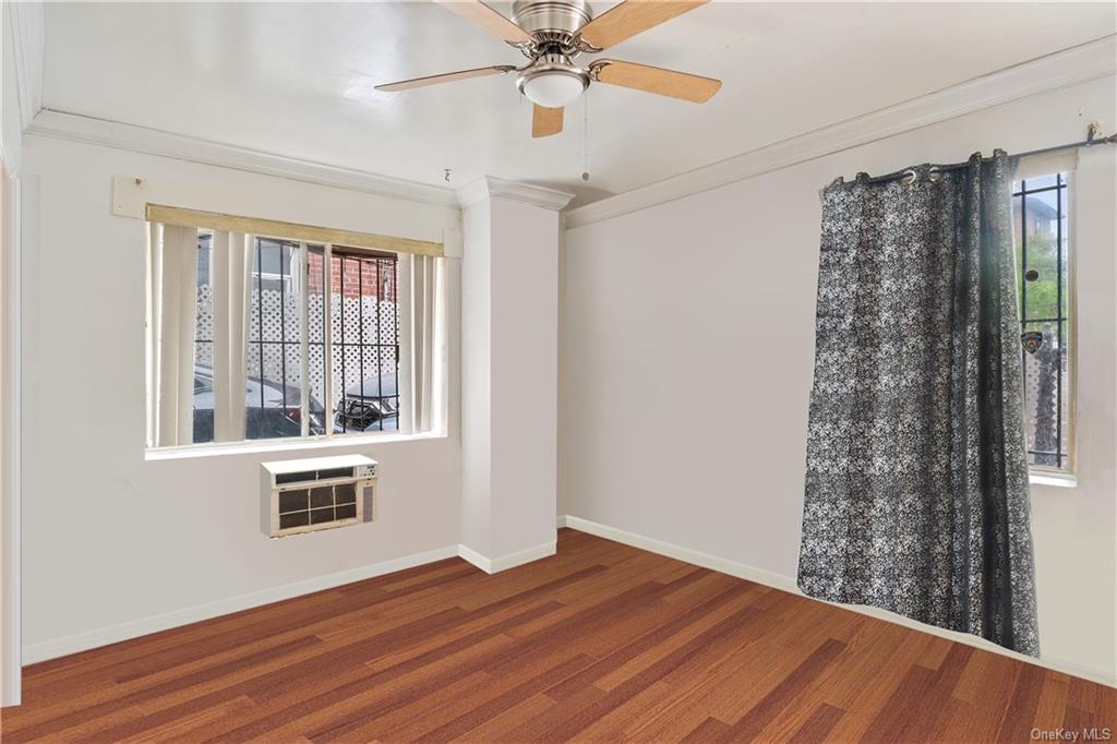 1653 Garfield Street Bronx, NY 10460 - Photo 8 of 21 a view of an empty room with a window and wooden floor