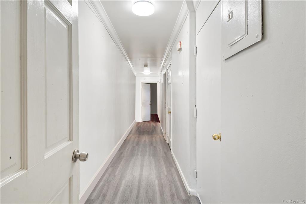 1653 Garfield Street Bronx, NY 10460 - Photo 9 of 21 a view of a hallway with wooden floor and staircase