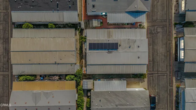an aerial view of a residential houses with yard