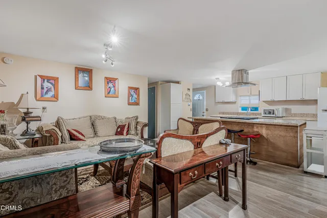 a view of a dining room with furniture and wooden floor