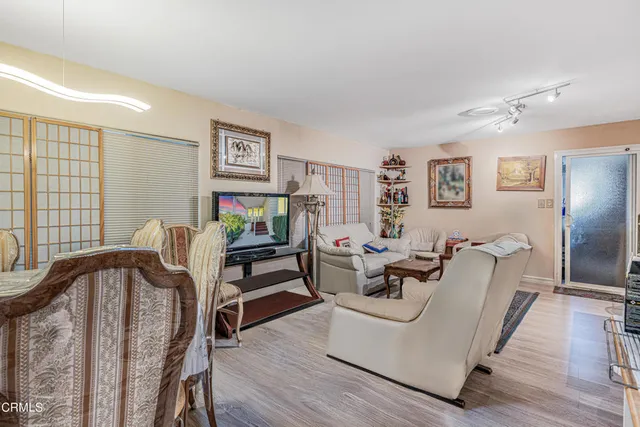 a living room with furniture and wooden floor