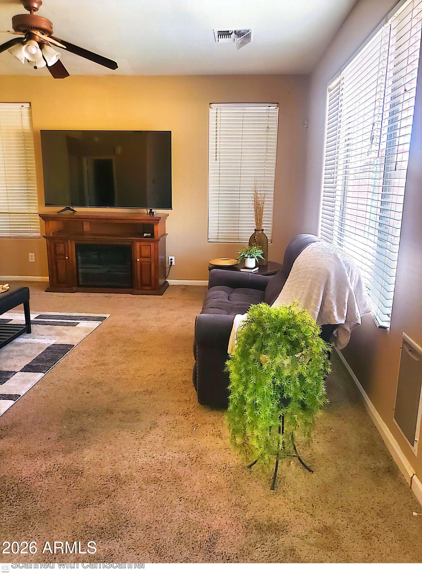 11058 East Cholla Road Mesa, AZ 85207 - Photo 7 of 22 a living room with furniture and a flat screen tv