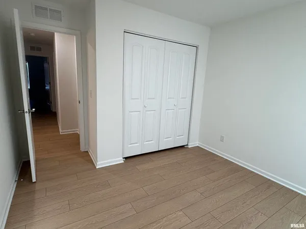 an empty room with wooden floor