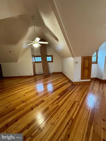 a view of a room with wooden floor