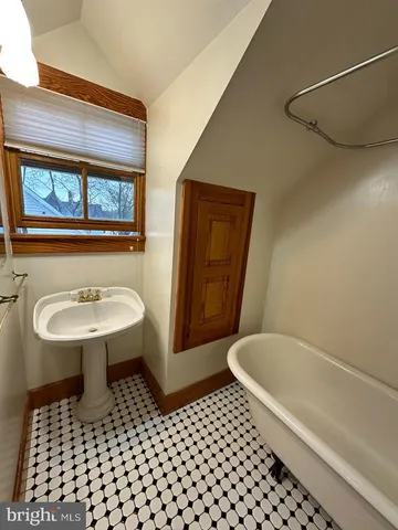 a bathroom with a sink a toilet a mirror and shower