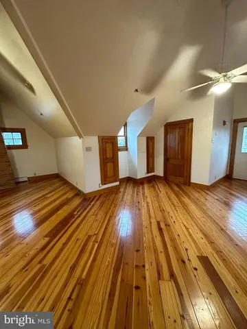 a view of a room with wooden floor