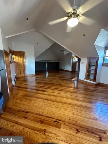 a view of a room with wooden floor