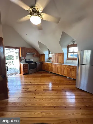 a view of a living room with wooden floor