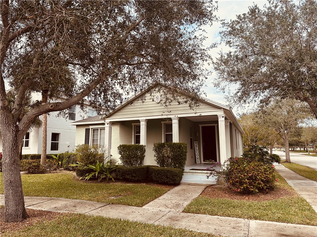 7710 15th Street Vero Beach, FL 32966 - Photo 1 of 25 a front view of a house with garden