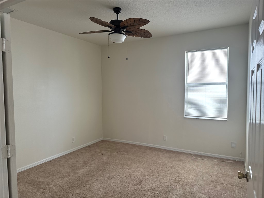7710 15th Street Vero Beach, FL 32966 - Photo 18 of 25 an empty room with a window and a fan