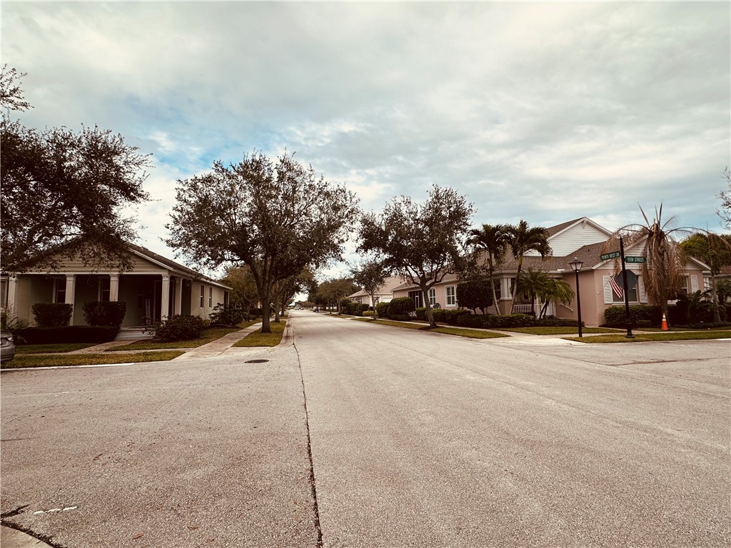 7710 15th Street Vero Beach, FL 32966 - Photo 23 of 25 a front view of a house with a yard and trees