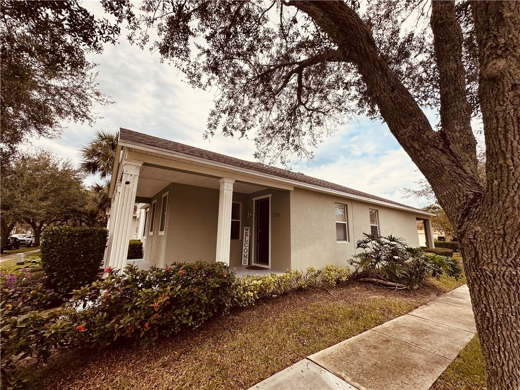 7710 15th Street Vero Beach, FL 32966 - Photo 3 of 25 a front view of house with yard