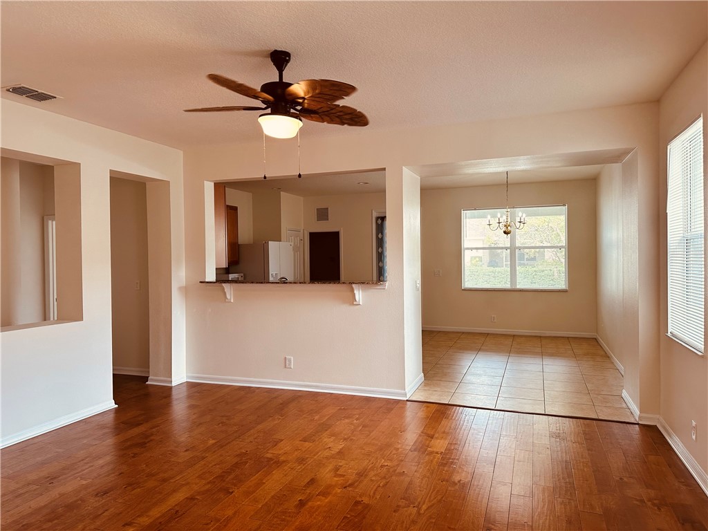 7710 15th Street Vero Beach, FL 32966 - Photo 4 of 25 a view of empty room with wooden floor and ceiling fan