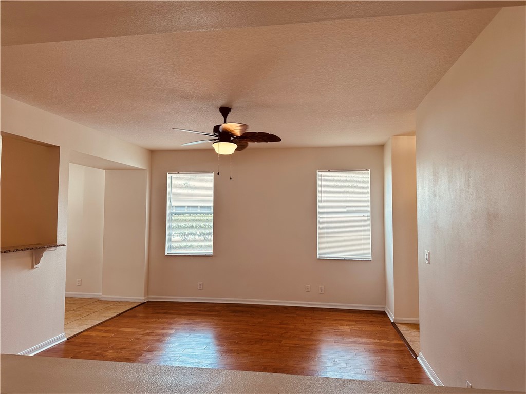 7710 15th Street Vero Beach, FL 32966 - Photo 5 of 25 an empty room with wooden floor cabinet and windows