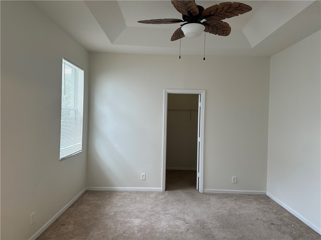 7710 15th Street Vero Beach, FL 32966 - Photo 9 of 25 an empty room with a ceiling fan and a window