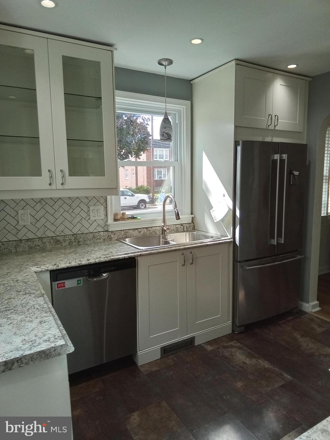 1917 Griffith Street Philadelphia, PA 19111 - Photo 12 of 50 a kitchen with granite countertop kitchen island stainless steel appliances a sink stove and refrigerator