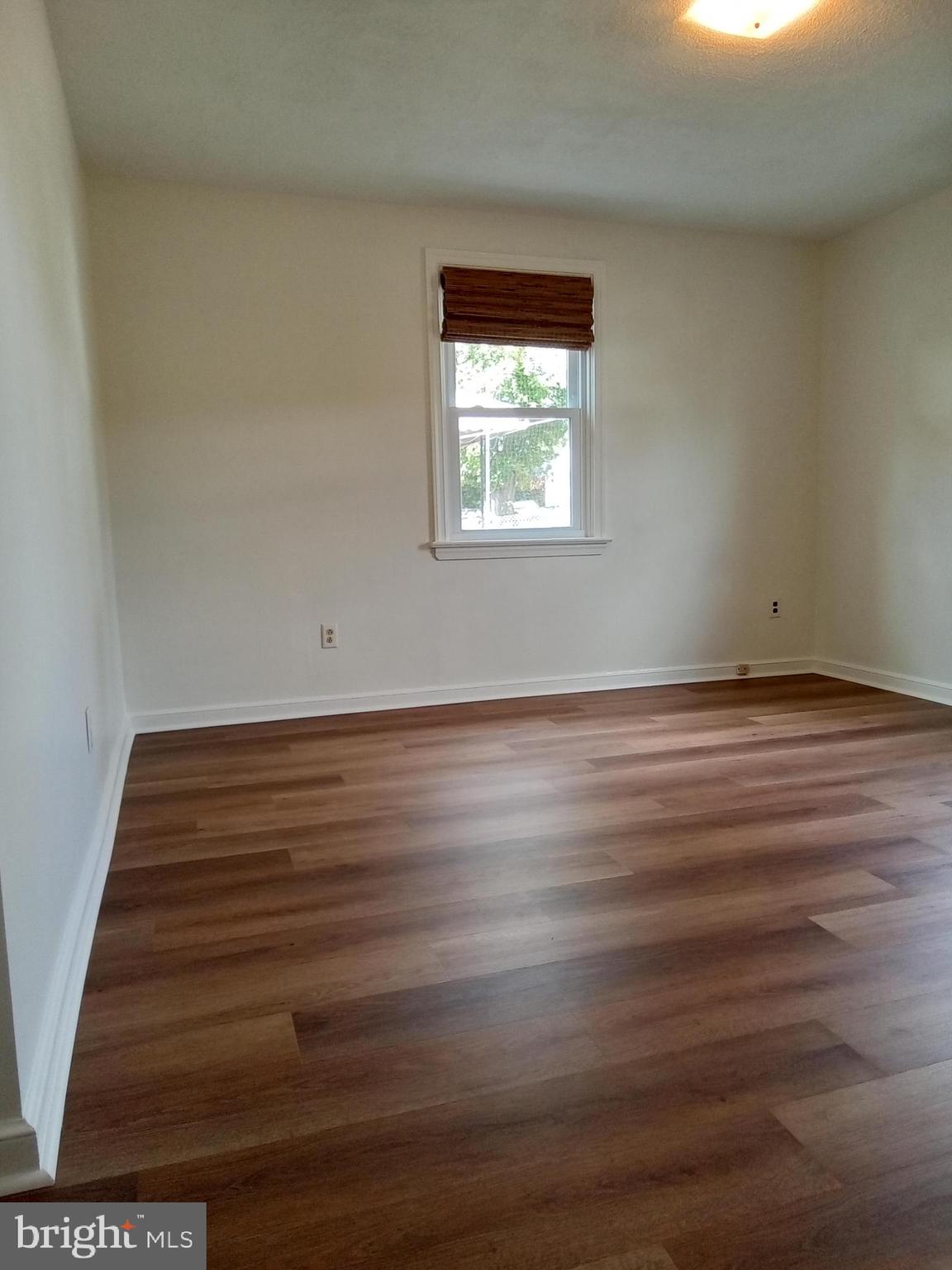 1917 Griffith Street Philadelphia, PA 19111 - Photo 22 of 50 a view of an empty room with wooden floor and a window