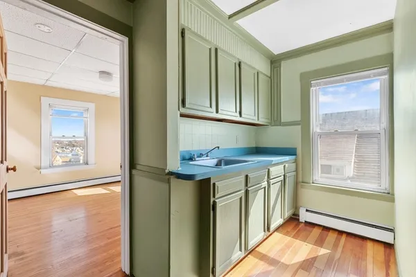 a view of a kitchen with a sink and a window