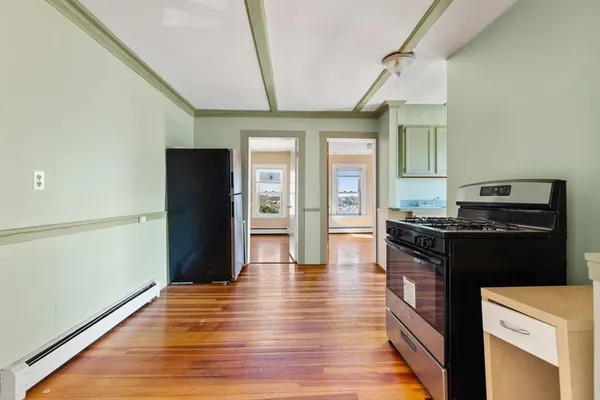 a kitchen with granite countertop a refrigerator and a stove