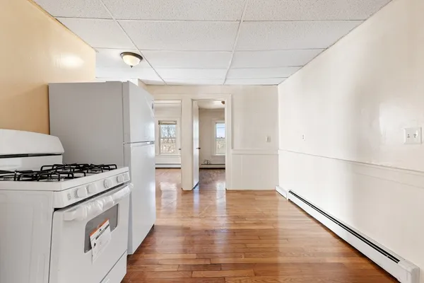 a kitchen with granite countertop a stove and a refrigerator